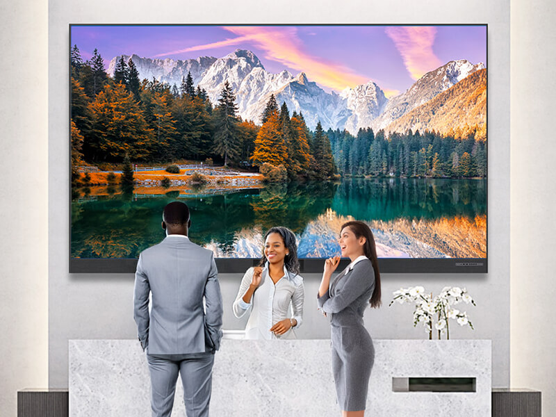 Modern office lobby with large mountain landscape artwork and professional business people