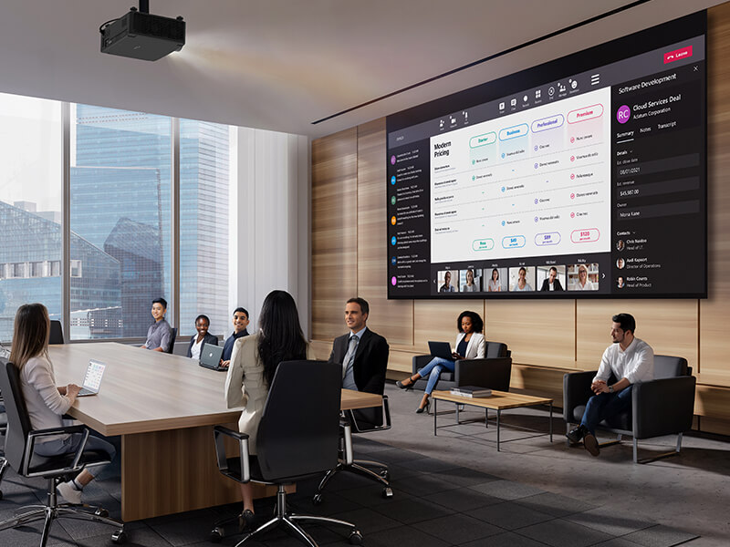 Business team meeting in modern boardroom with large wall-mounted presentation display and city view