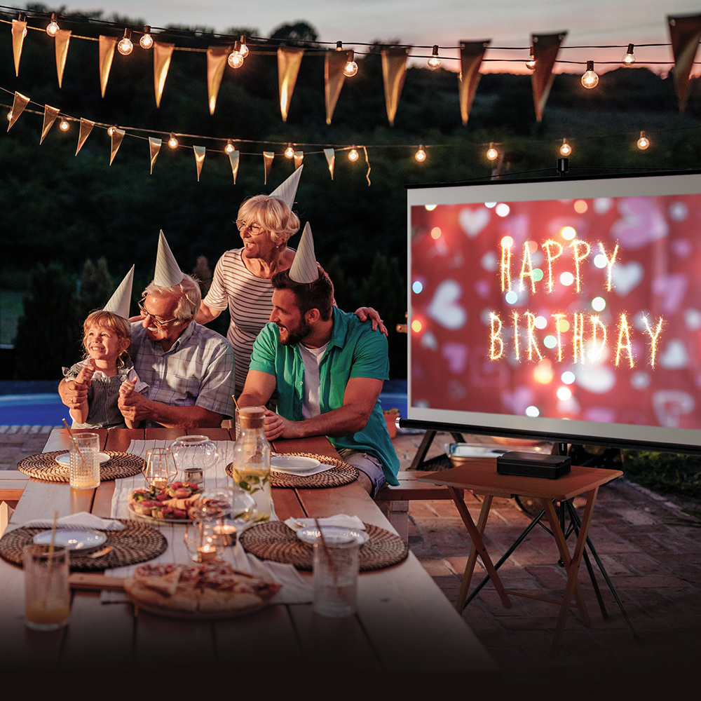 Family outside using a projector