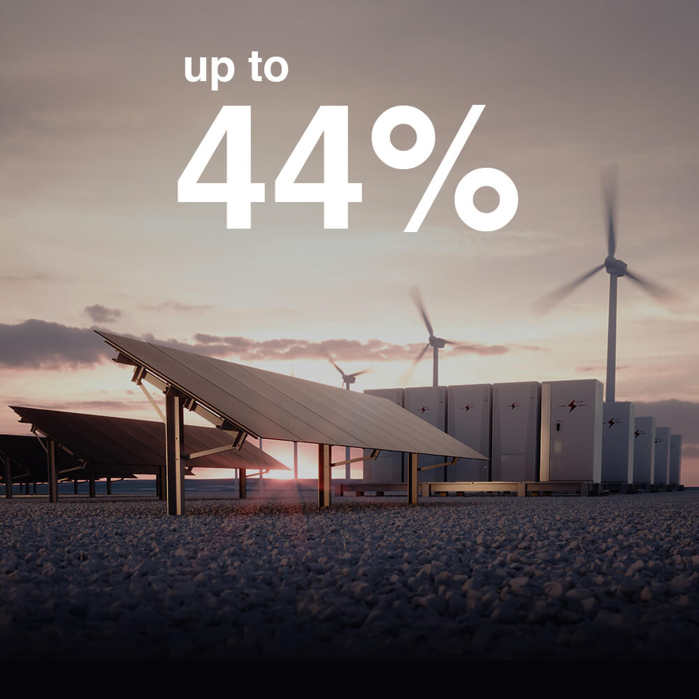 Solar panels and wind turbines at renewable energy facility demonstrating 44% energy savings and reduced carbon emissions for sustainable power generation