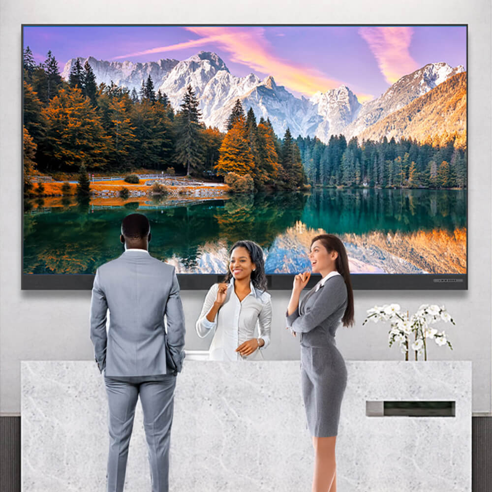 Three business professionals in gray suits standing in elegant office lobby with large wall-mounted landscape painting featuring snow-capped mountains, autumn trees, and lake reflection, modern white marble reception desk in foreground