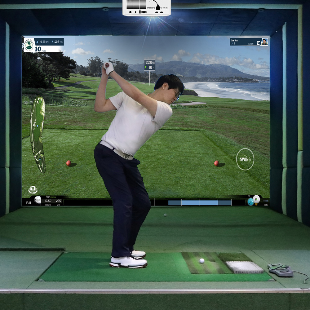 Female golfer swinging a golf club in immersive golf setup