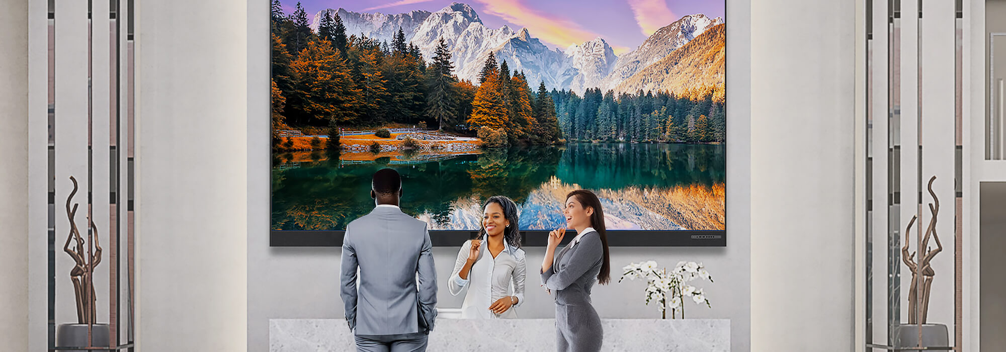 Large format mountain landscape wall art in modern office reception lobby with business professionals and contemporary interior design