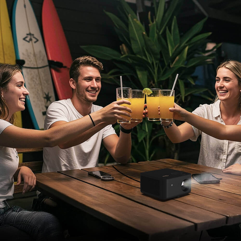 Patio gathering with friends using Optoma Photon Life 4K UHD projector featuring built-in 5W speaker