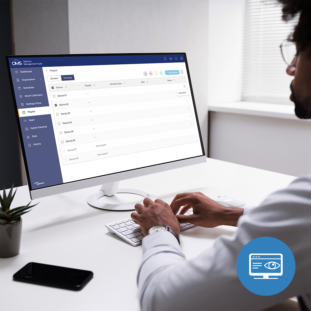 Person monitoring Optoma LED displays on a computer using Optoma Management Suite Cloud (OMSC) with real-time system alerts