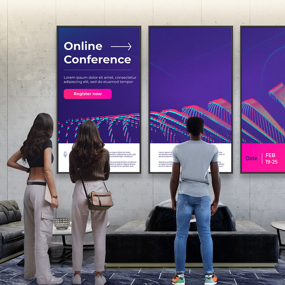 A university hallway that has multiple portrait screens with imagery that continues through each of them. The visual is sharp and is advertising an online conference.
