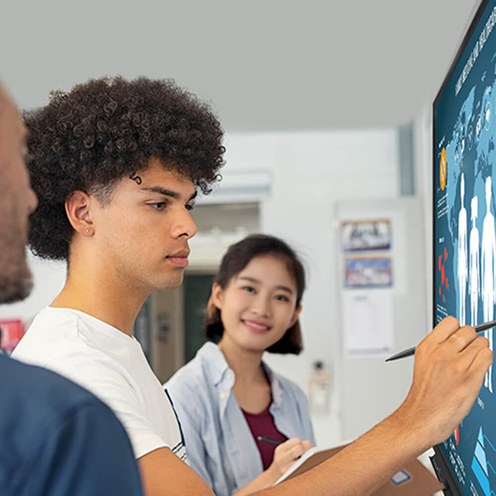 Students engaging with interactive touchscreen display in a smart classroom powered by education technology solutions